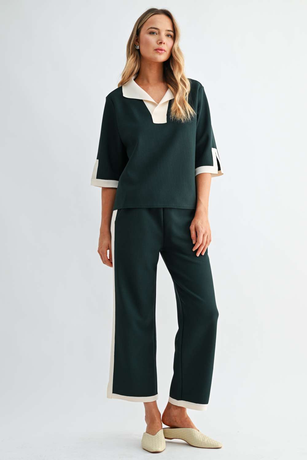 Women’s forest green wide-leg pants with cream side stripe and contrast hem trim