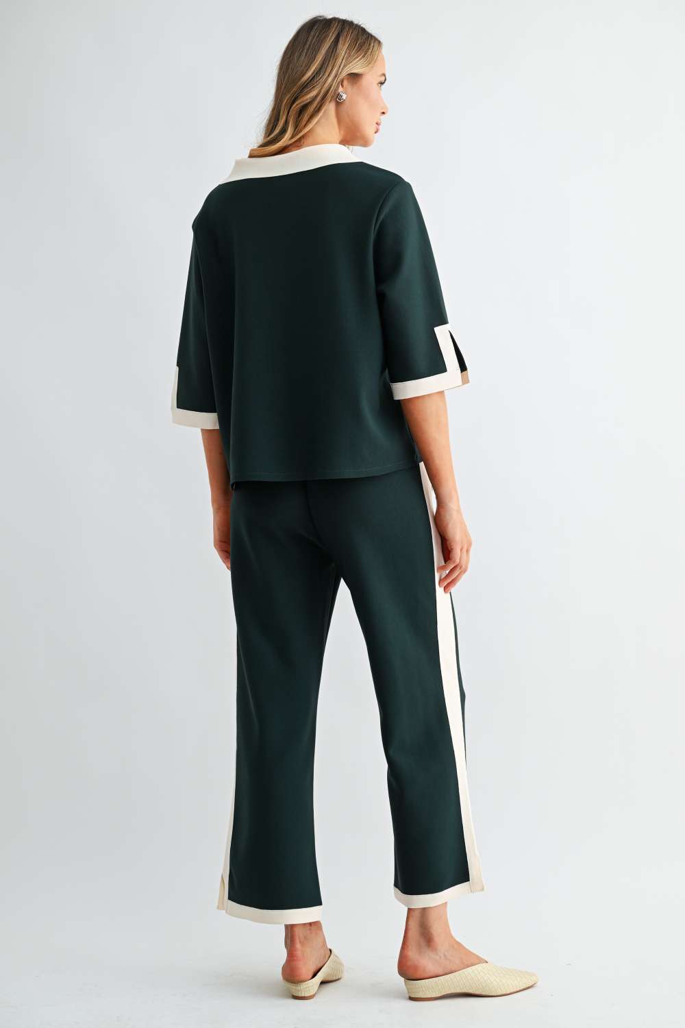 Back view of Kristopher forest green wide-leg pants with cream contrast stripe